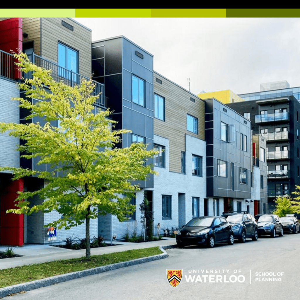 A wide shot of a 3-storey apartment building with cars parked in front. 