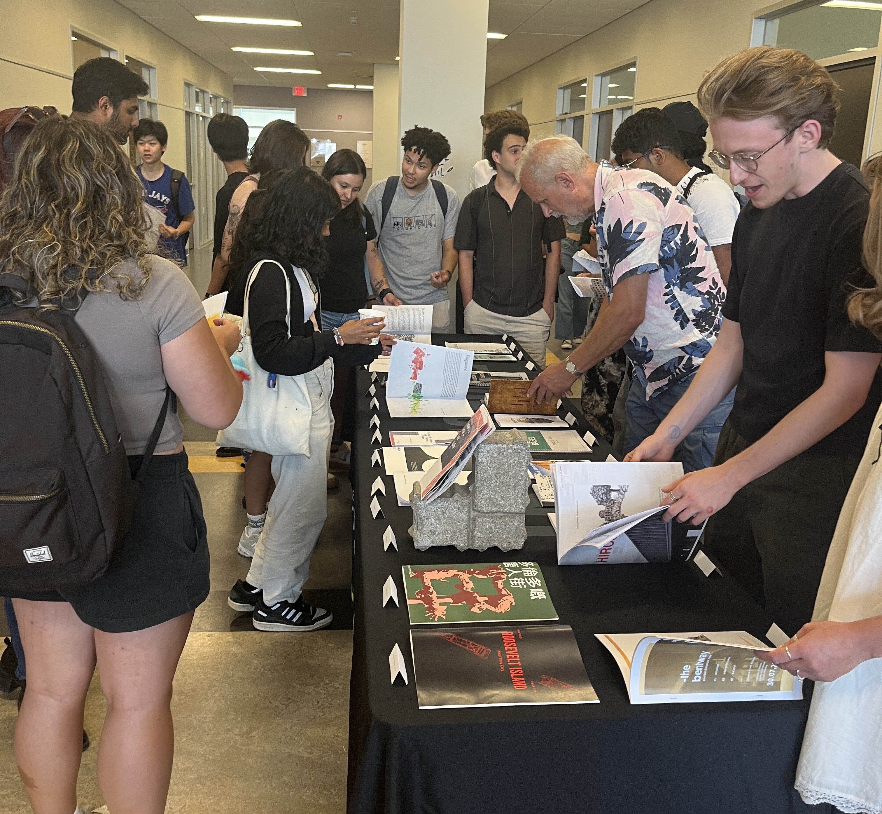 Group of students looking at booklets 