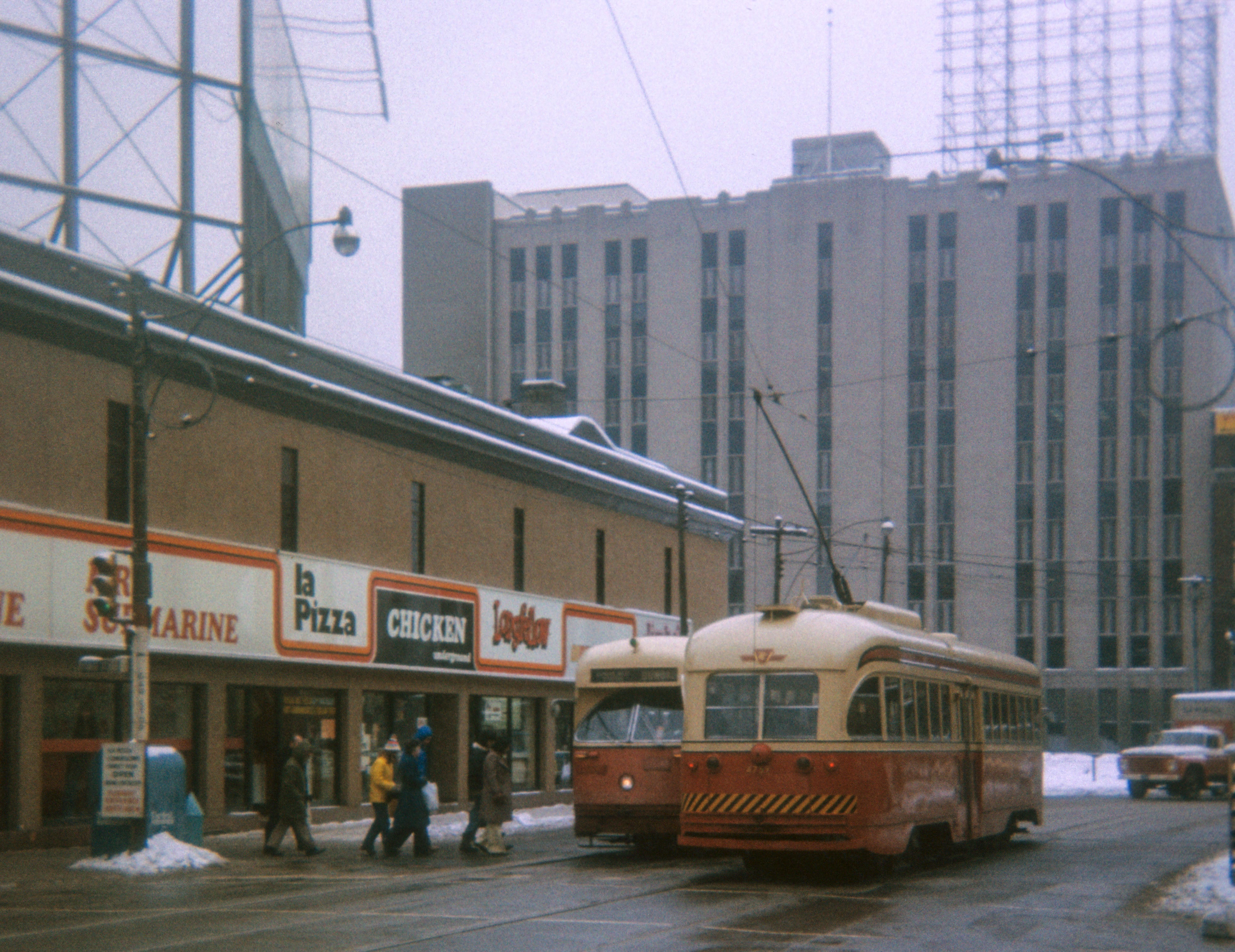 Toronto streetcar pictured near a series of restaurants.
