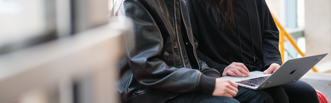 Two people looking at a laptop