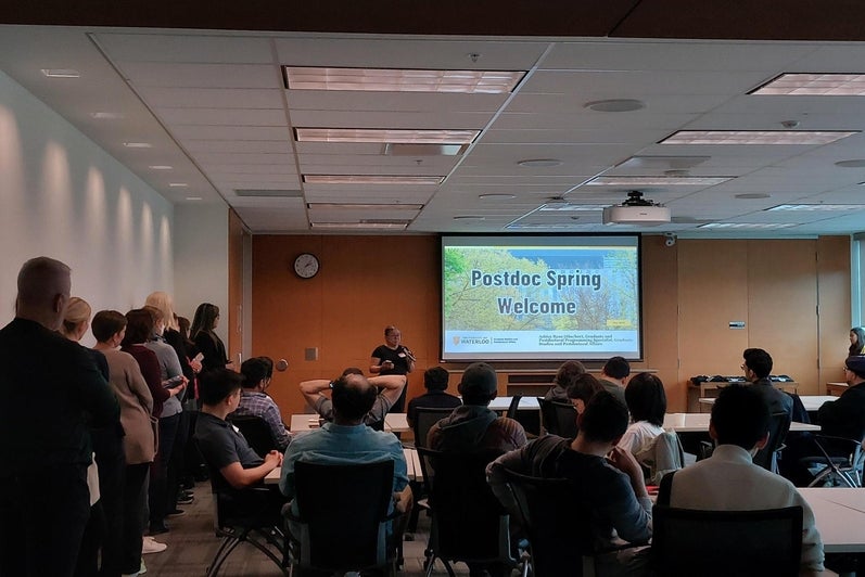 A group of people watching a presentation