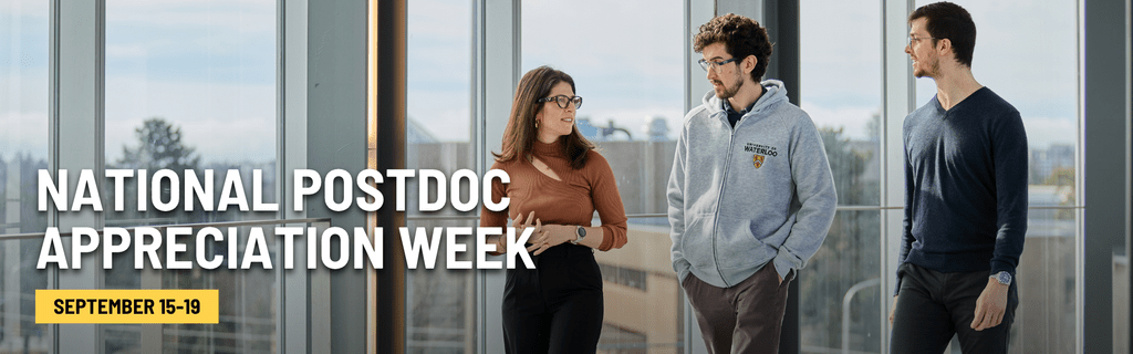 Three postdocs walking down a hall