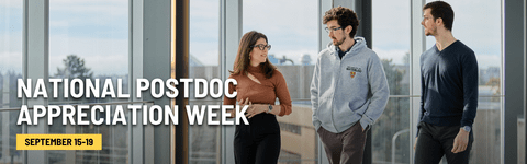 Three postdocs walking down a hall