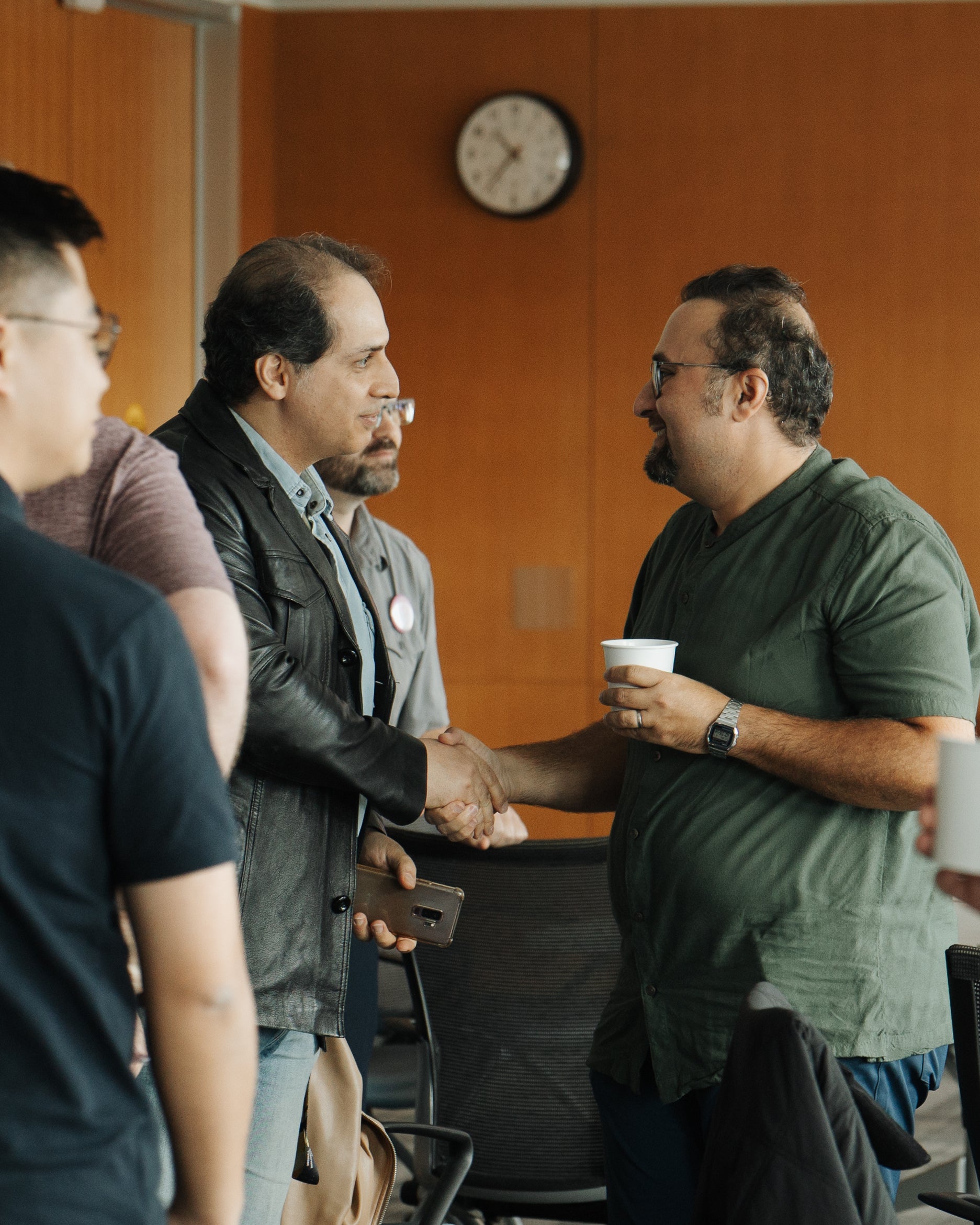 Two postdocs shaking hands