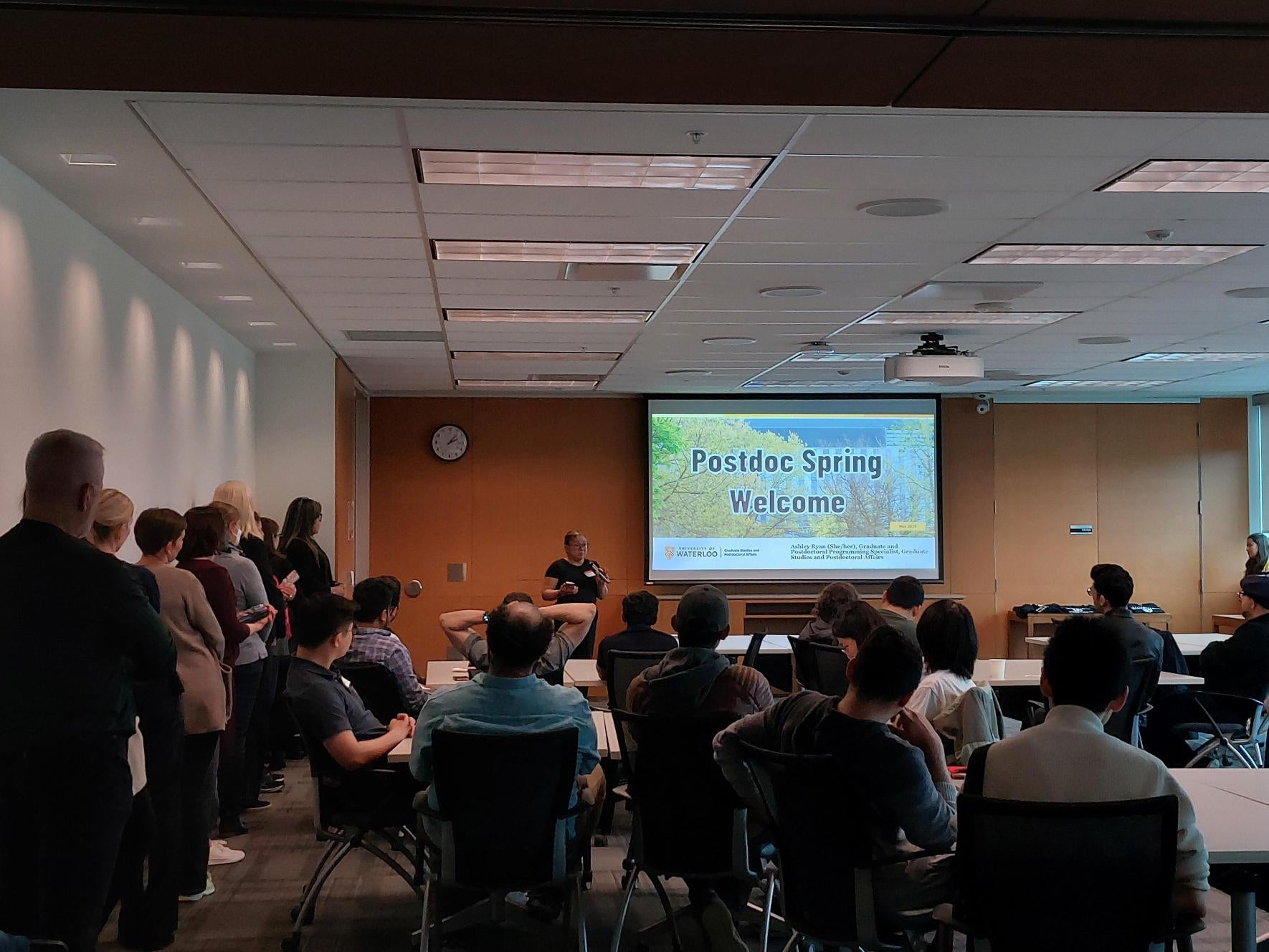 A group of people watching a presentation