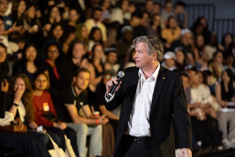 President Rosehart speaking to audience of students at Grad Orientation