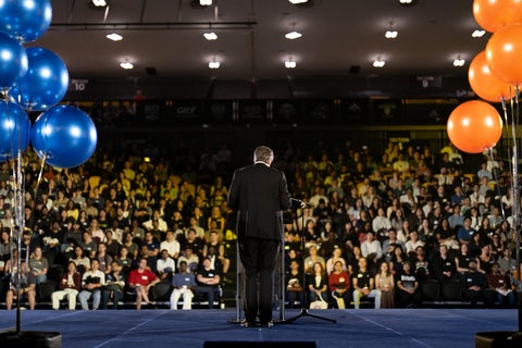 Bill from behind bat a podium
