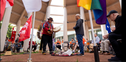 Two men standing facing each other one is president Goel, the other, Elder Myeengun Henry