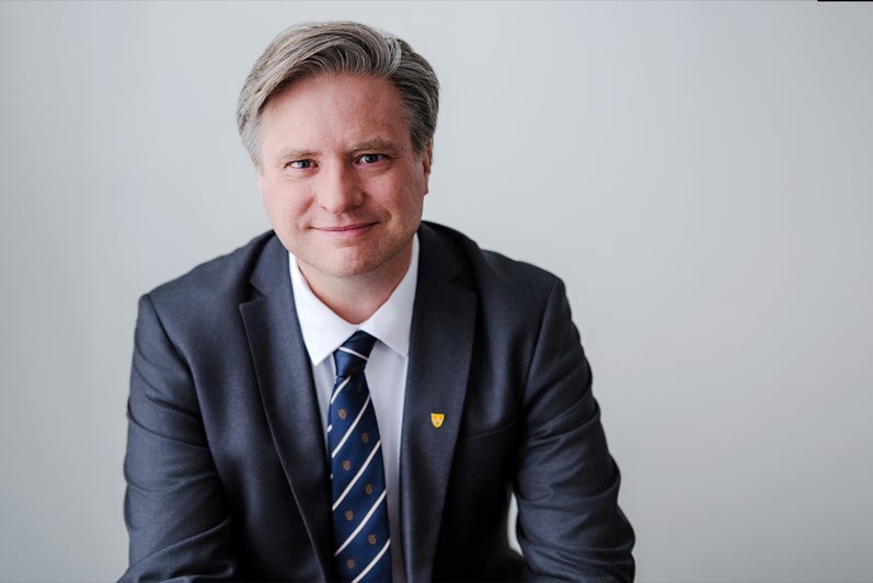 Dr. Rosehart in a suit sitting