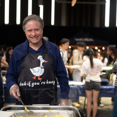 Bill serving food to students at the WUSA welcome