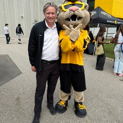 Bill standing with the UW mascot