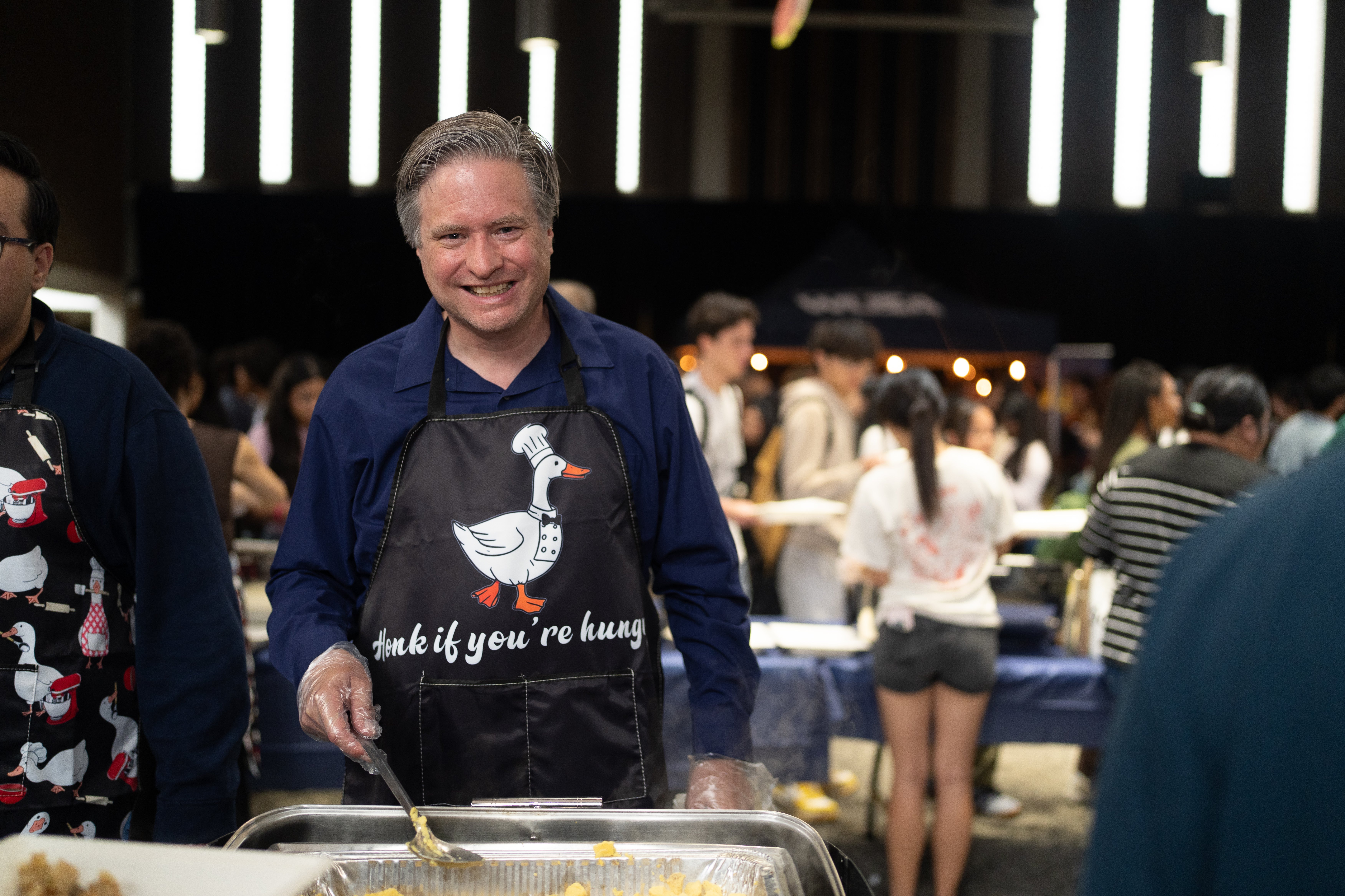 Bill serving food to students at the WUSA welcome