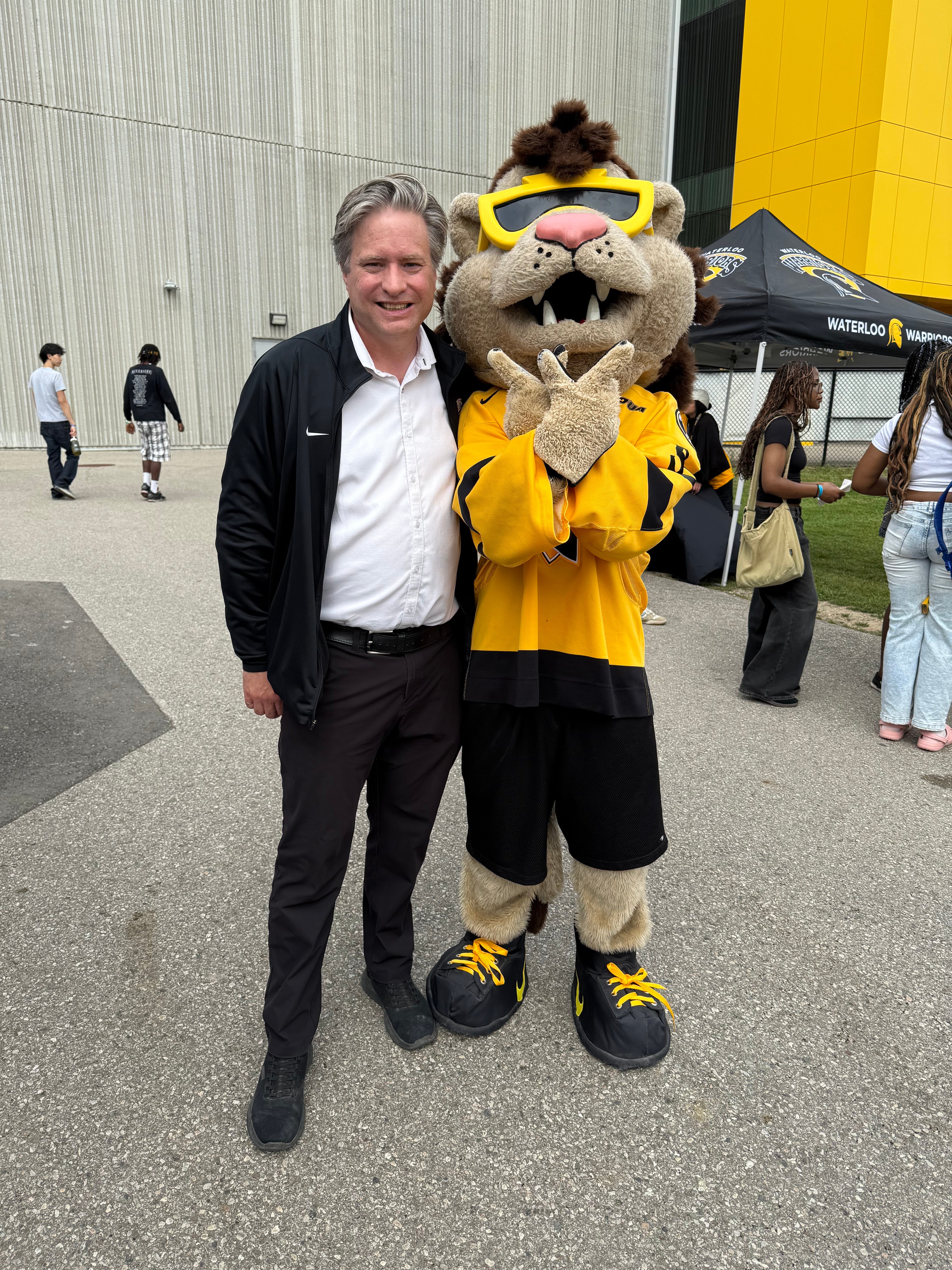 Bill standing with the UW mascot