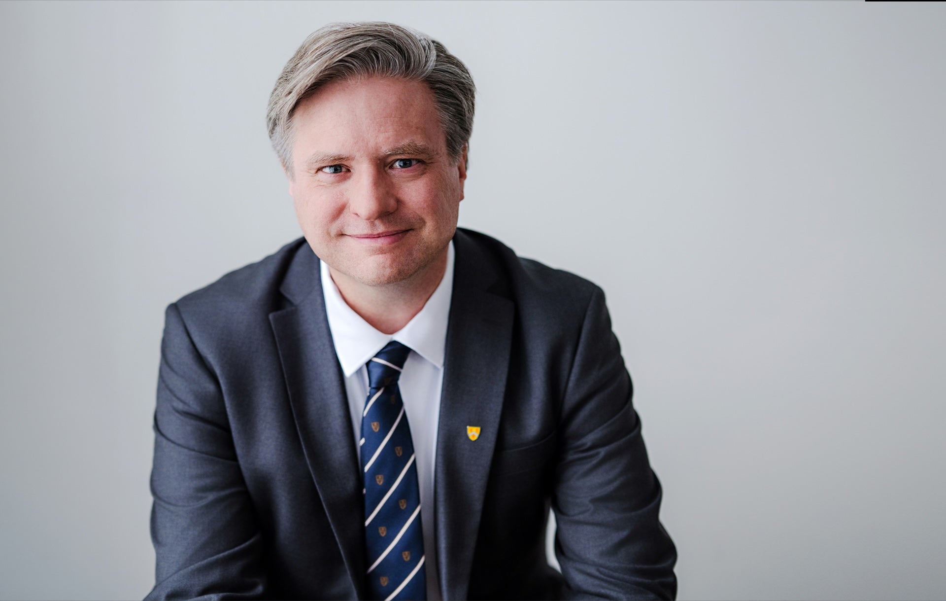 Dr. Rosehart in a suit sitting