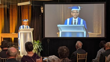 President Goel speaks at a podium during his installation