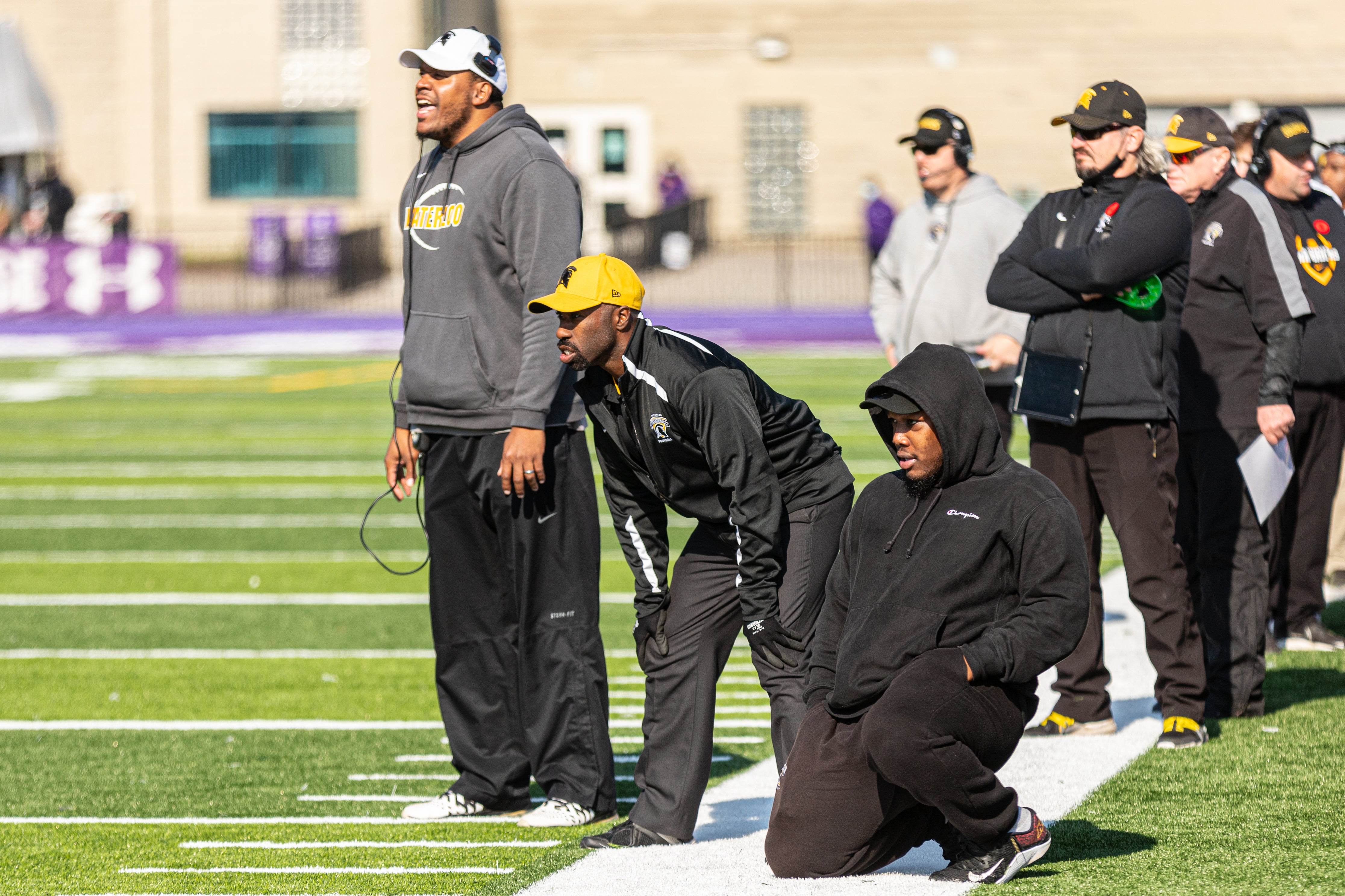 Coach and athletes looking into the field