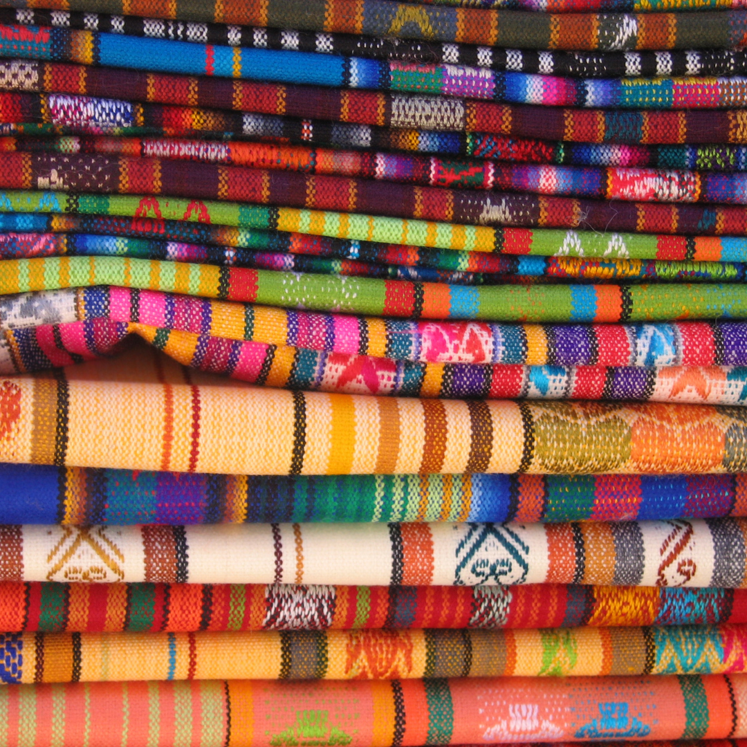 A stack of fabric with bright, colourful patterns