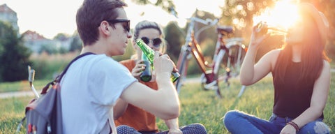 Teens drinking beer at sunset