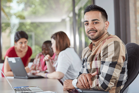 Graduate student sitting at table