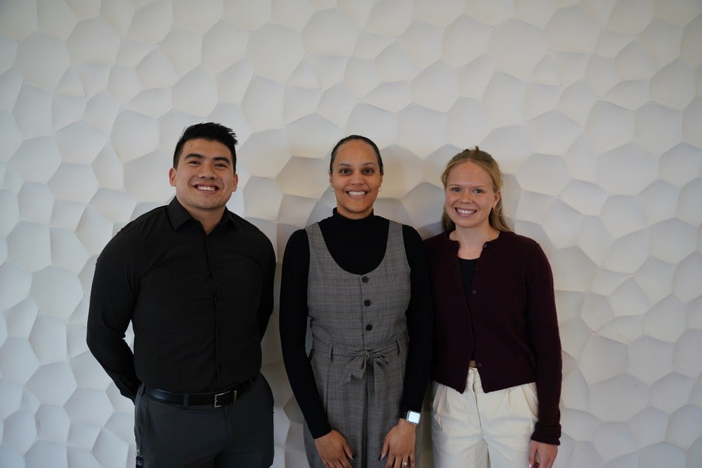 From left to right: Ryan Chen, Sheereen Harris, and Hannah Johnson at Kinesiology and Health Sciences Research Day, posing in front of a white backdrop