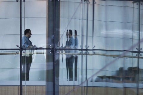 Man standing behind several layers of glass walls