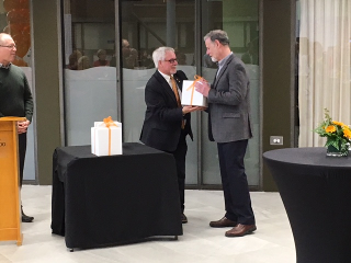 Dean Douglas Peers shakes Derek Besner's hand to congratulate him for receiving the 2017 Excellence in Arts Research Award!