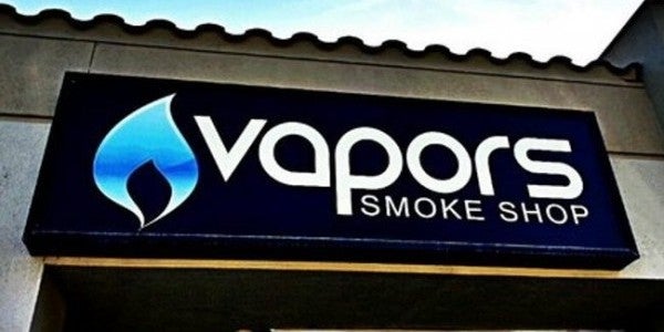 picture of a sign - blue flame with the word VAPORS next to it