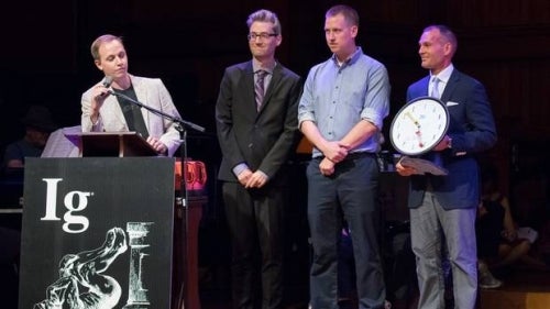 Gordon Pennycook at podium accepting Ig Nobel prize with Derek Koeher, Nathaniel Barr and Jonathan Fuglesang standing beside him