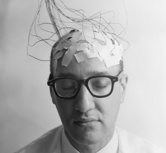head shot of man with taped wires coming from his head