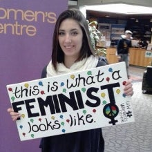 Sarah Wiley holding a sign that states - this is what a feminist looks like