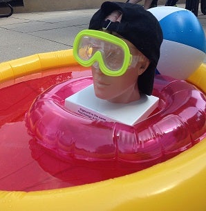 Sigmund floating in inflatable pool on patio