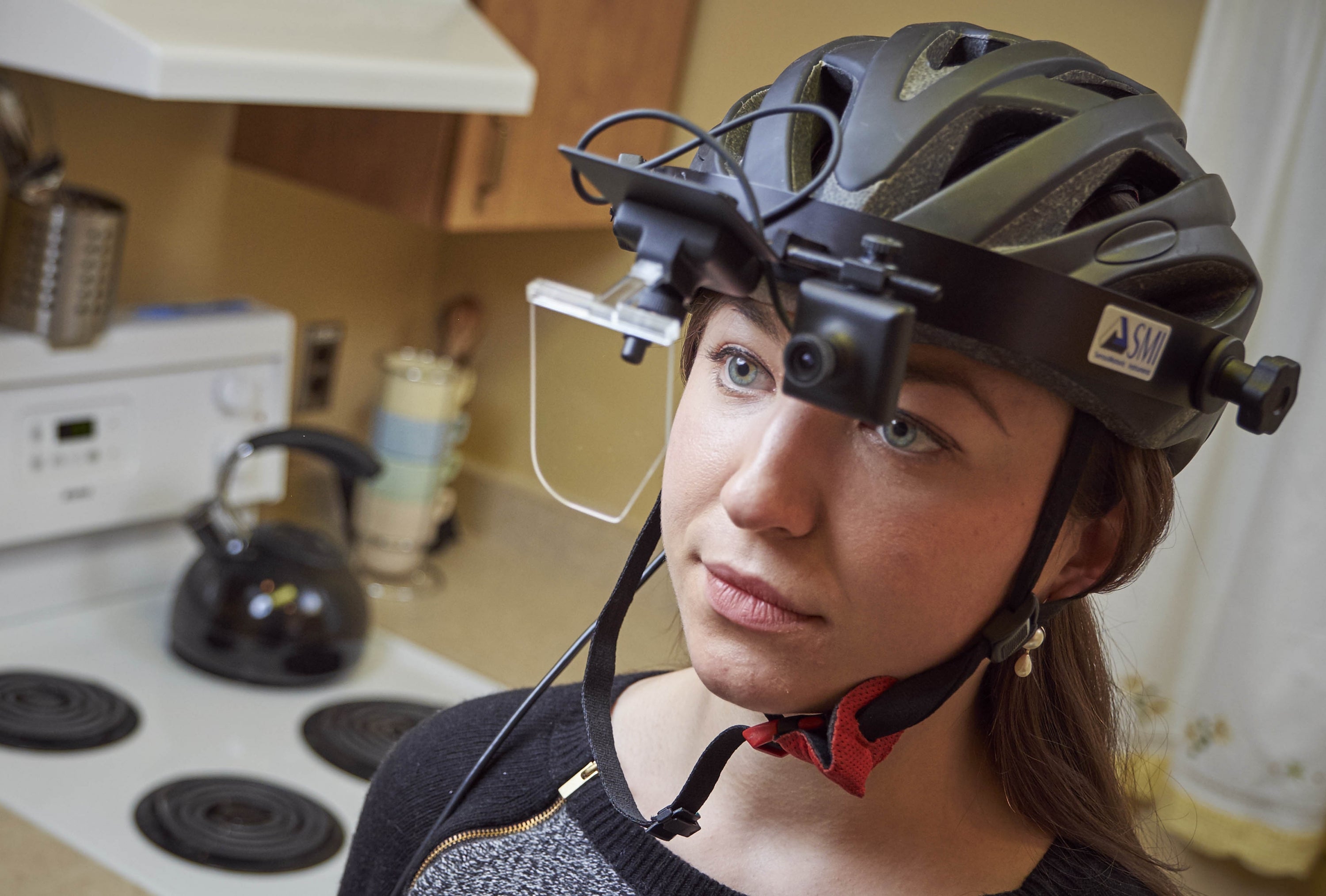 Girl wearing eye tracker device as example of a visual attention experiment