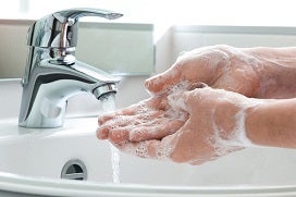 lathered hands rinsing off at tap and sink