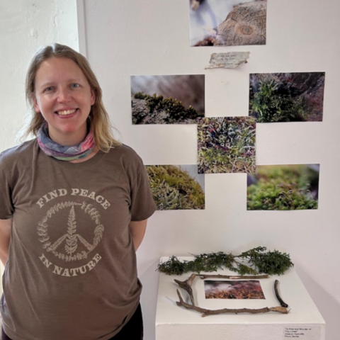 Josalyn standing in front of her project display