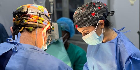 Dr. Jivani-Tajdin and colleague performing surgery in operating room.