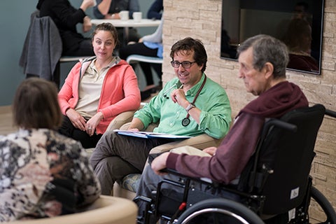 Dr. Heckman and grad student talking to residents of a long-term care village.