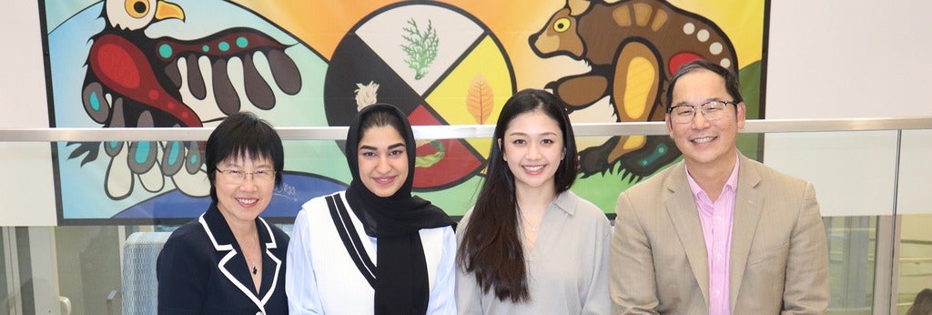 Helen Chen and research team in front of Indigenous painting.