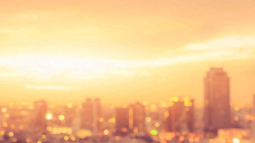 Fiery sun beats down on city apartments and buildings.