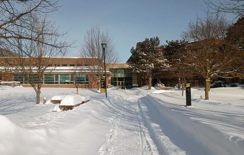 Winter view of University of Waterloo Health buildings and snowy path.