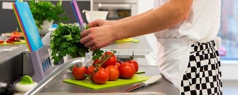 Teenager at food prepping station with vegetables