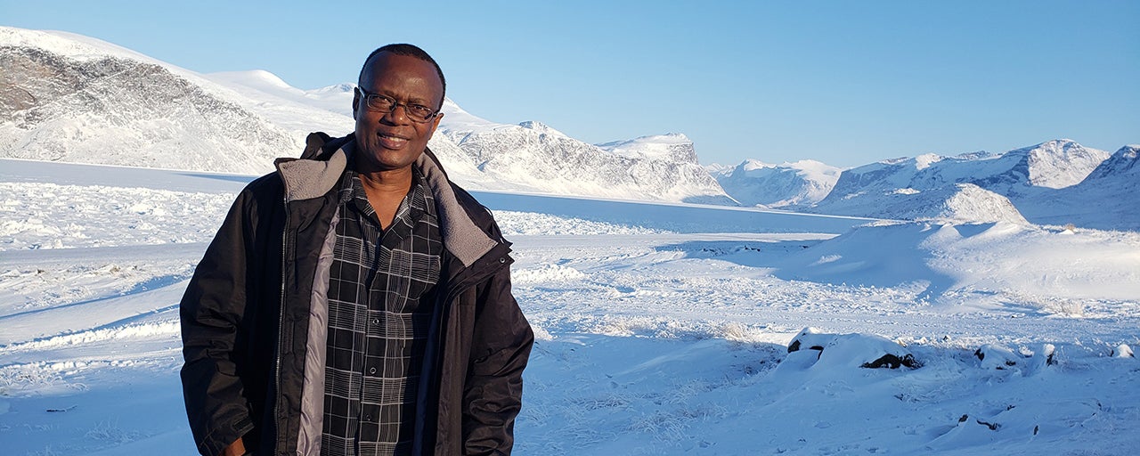 Wilfred Ntiamoah standing in arctic tundra