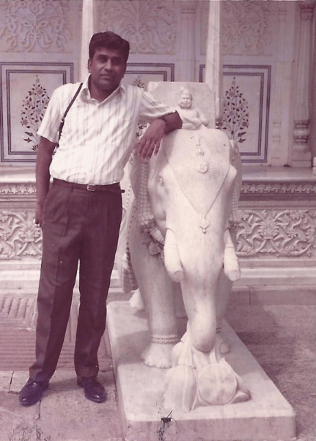 Dr. P. L. Kannappan standing next to a statue