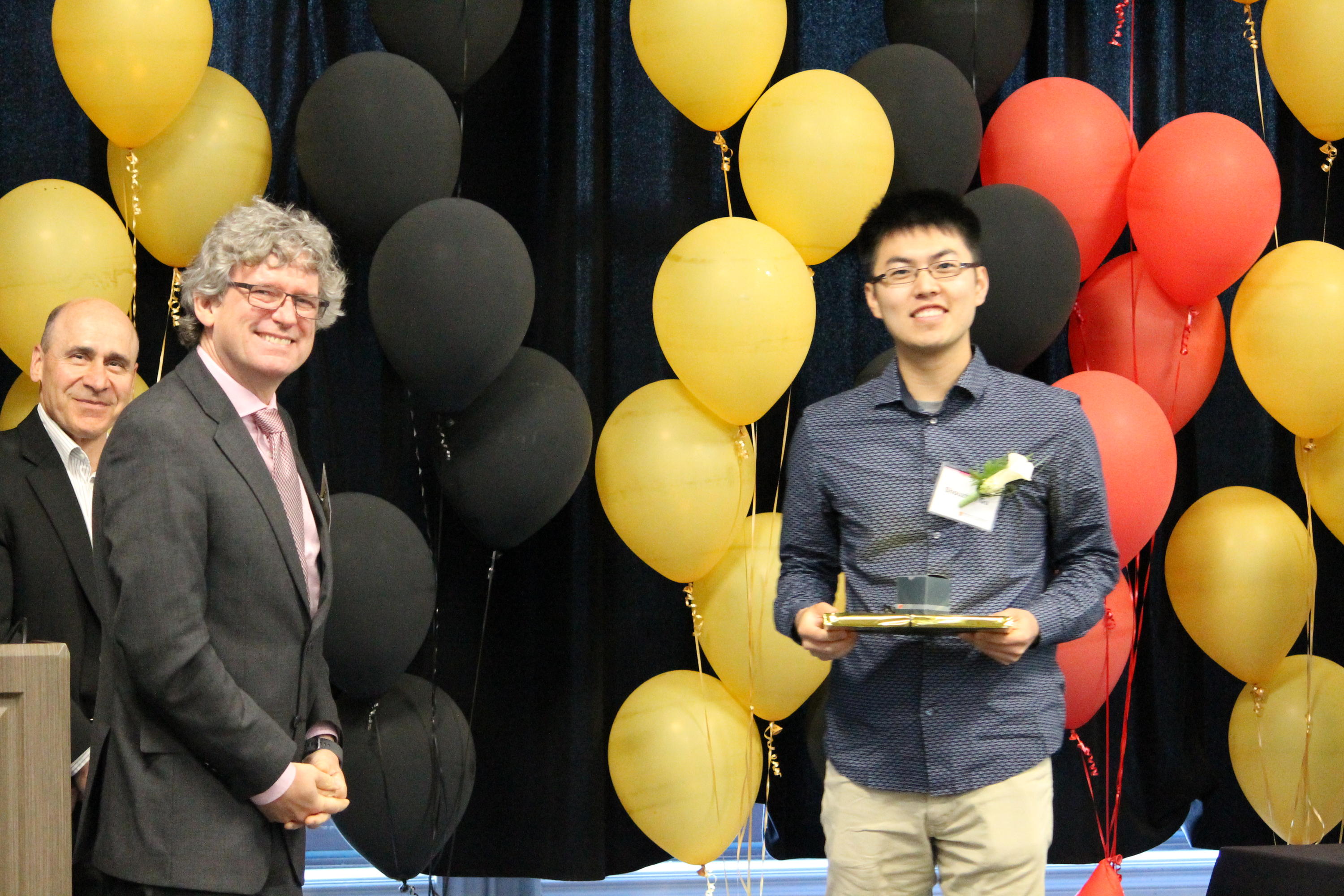 Bailey Gu is honoured by Dean Stephen Watt and Associate Dean Serge D'Alessio at the Faculty of Mathematics Convocation Dinner