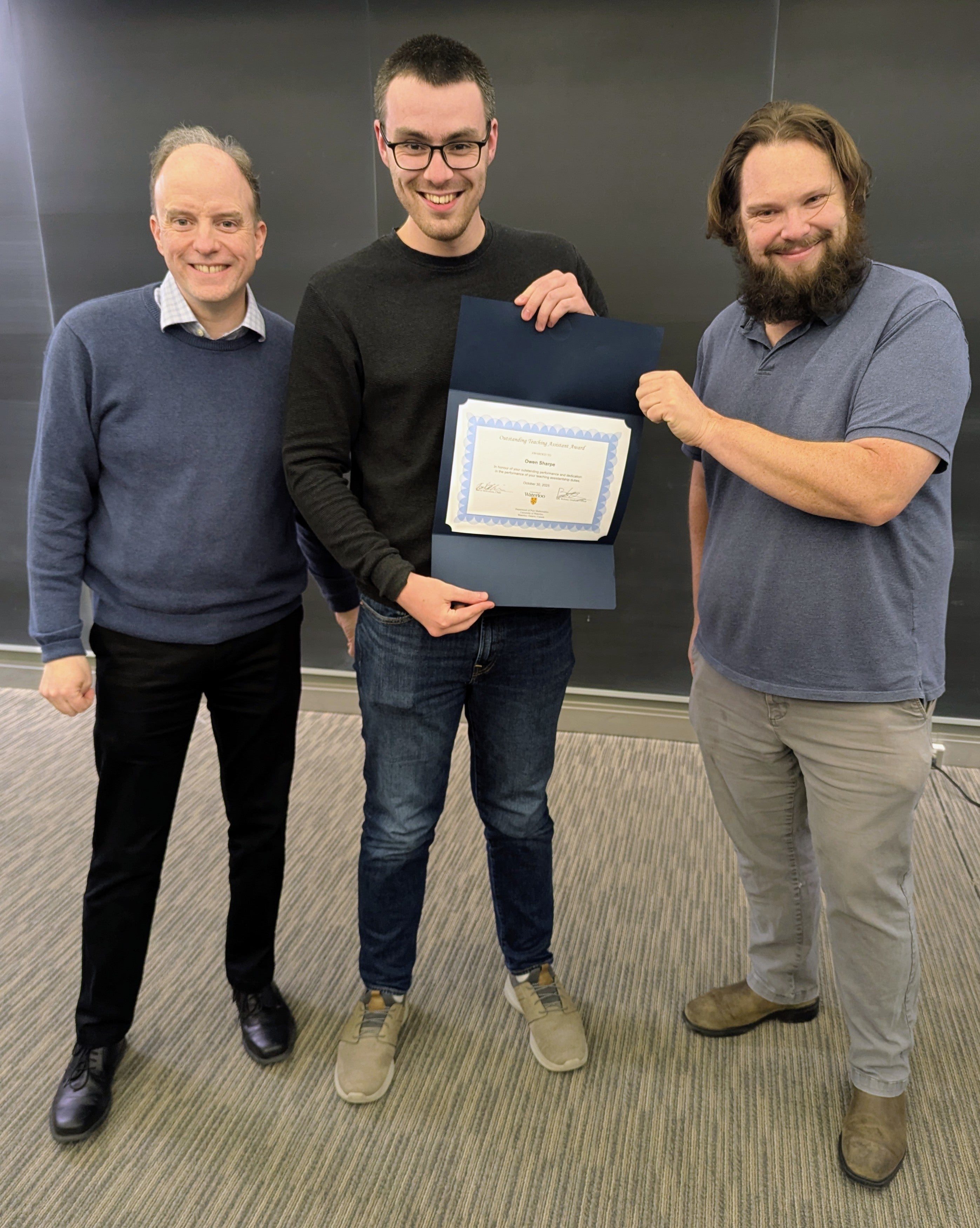 David McKinnon and Ben Webster presenting Owen Sharpe with an award
