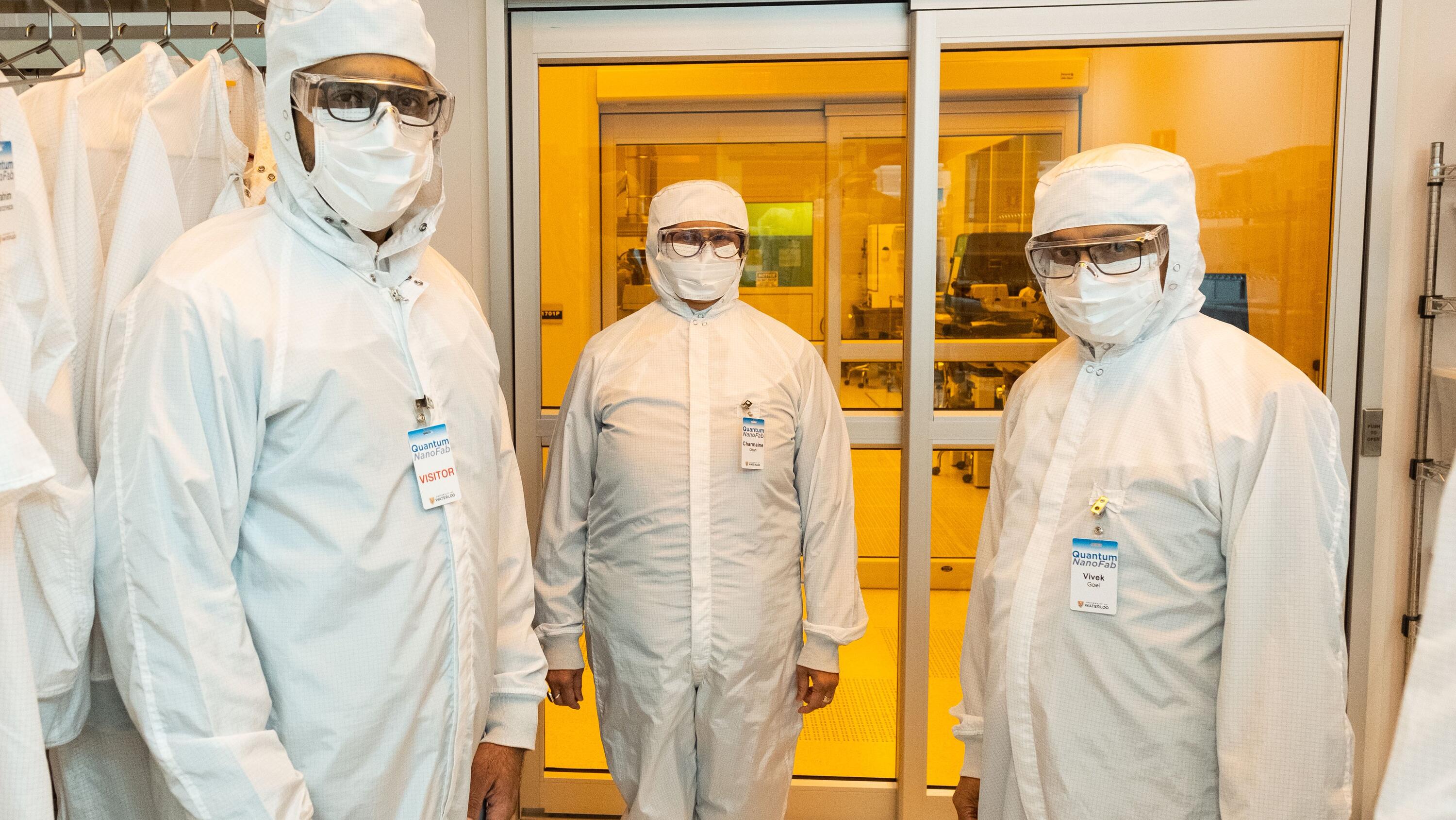 Dignitaries in cleanroom suits