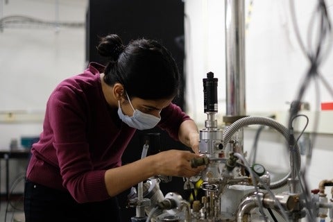 Ambature’s Research and Development Scientist, Archana Tiwari, connects measurement electronics to a cryostat to test her device's performance at low temperatures in the Quantum Colab.