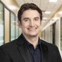 Troy Borneman standing in a hallway. 