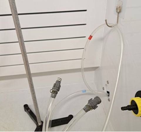 Tubing inside the fume hood featuring open quick-turn couplings with shut off