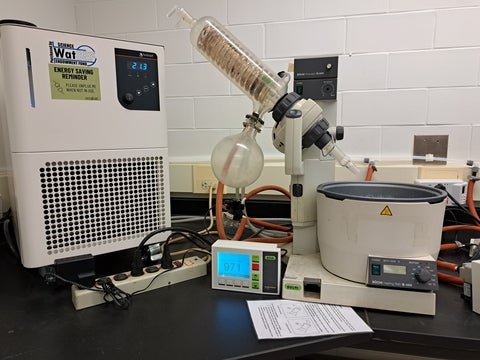 Rotary evaporator on lab bench connected to controller and chiller