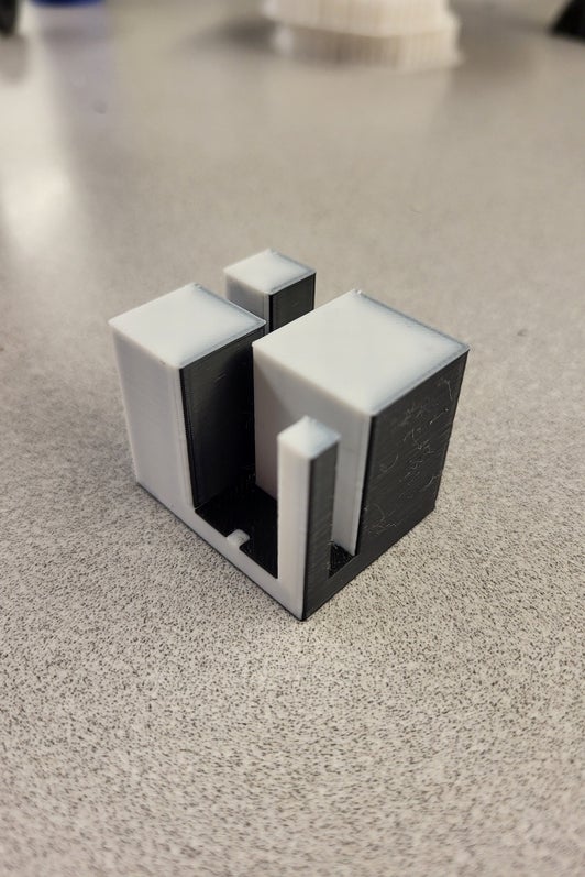 Black and white 3d printed part consisting of various sized rectangular prisms